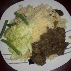 A picture of Ox liver with green salad.
