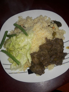 A picture of Ox liver with green salad.