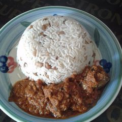 A picture of Rice and beans combo with stew.