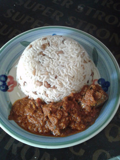 A picture of Rice and beans combo with stew.