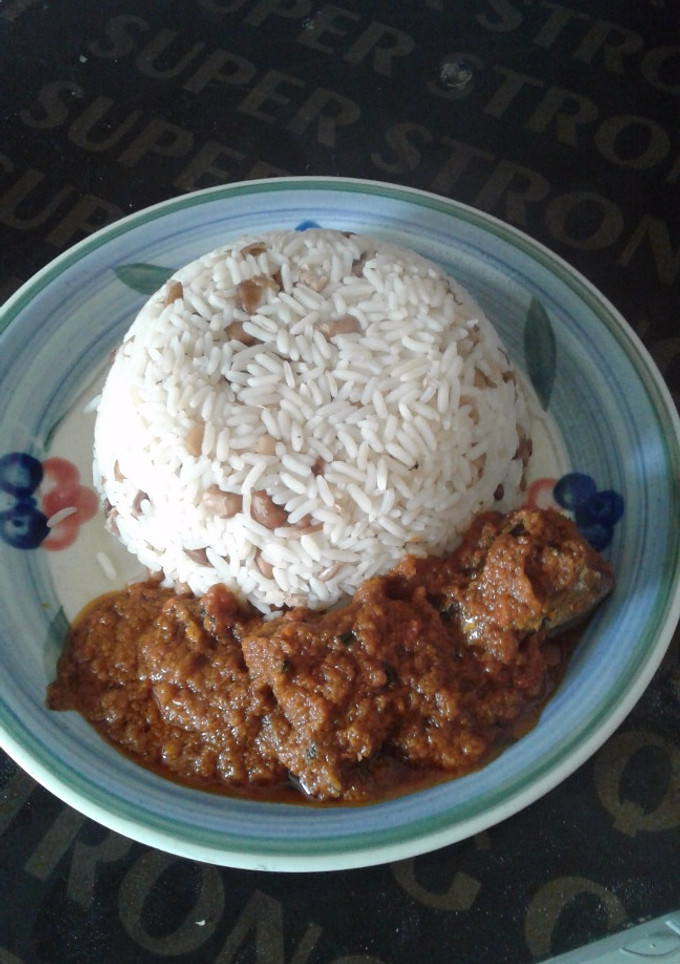 A picture of Rice and beans combo with stew.