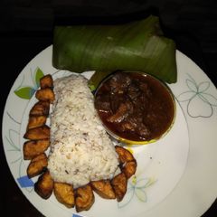A picture of Ofada rice, sauce and and plantain.