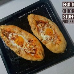 A picture of Egg top chicken stuffed pide bread(turkish pide).
