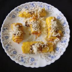A picture of Schezwan cheesy khandvi.