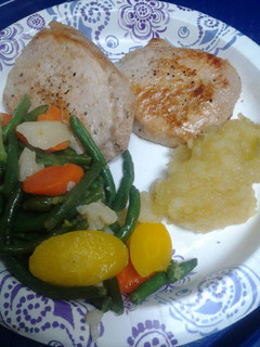 A picture of Brady Bunch pork chops and homemade apple sauce.