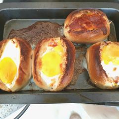 A picture of My Cheesey Bacon & Egg in a bread basket. 😁.