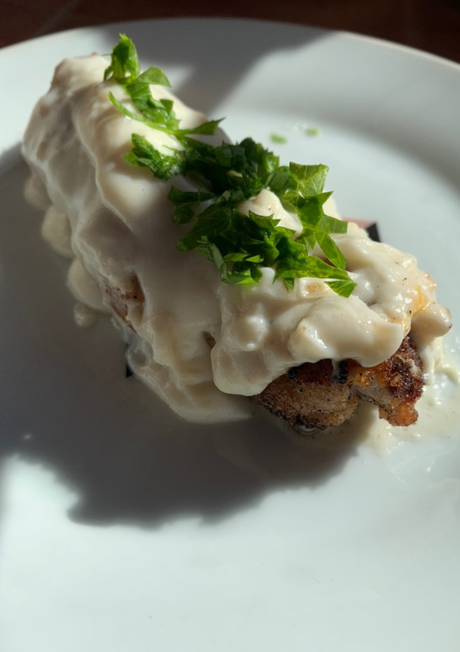 Una foto de Rollitos de cecina rellenos acompañados de salsa bechamel
