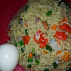 A picture of Vegetable noodles with boiled egg.