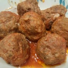 A picture of Mozzarella stuffed meatballs in slow cooker.