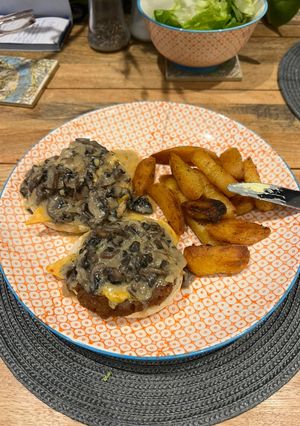 A picture of Open Burgers with mushroom sauce & fries.
