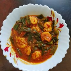 A picture of Prawn curry cooked with onion stalks.