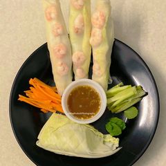 A picture of Vietnamese style Shrimp Roll with red chilli sauce.