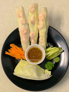 A picture of Vietnamese style Shrimp Roll with red chilli sauce.