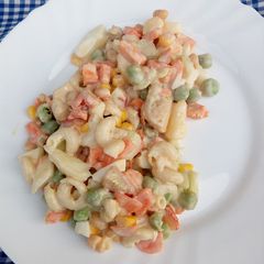 A picture of Veggies, pasta and chicken salad.