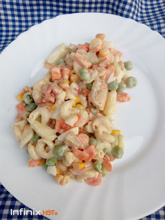 A picture of Veggies, pasta and chicken salad.