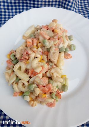 A picture of Veggies, pasta and chicken salad.