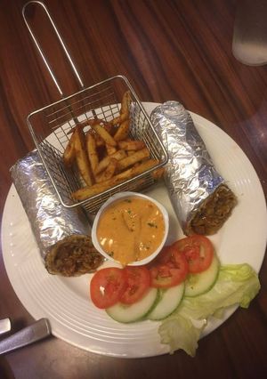 A picture of Veg Kathi Roll.Masala Fries.Makhani Gravy.With Salad.