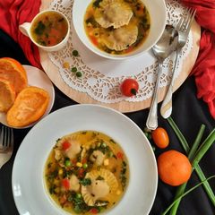 A picture of Orange flavour sweet & sour soup with besan ravioli.