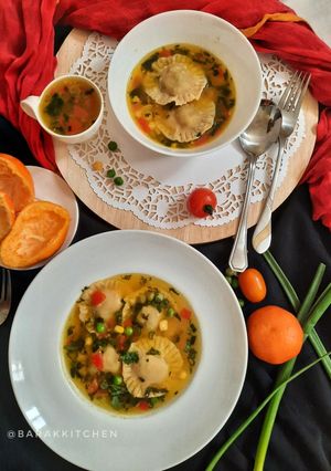 A picture of Orange flavour sweet & sour soup with besan ravioli.