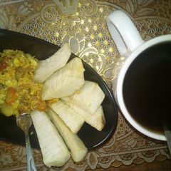 A picture of Fried yam wit scrambled egg/ black tea.