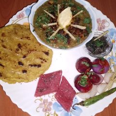A picture of Traditional Punjabi sarson da saag and makki di roti🌽🌿🧅🌶️.