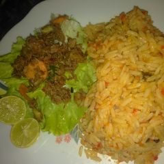 A picture of Jallof rice with salad.