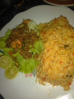 A picture of Jallof rice with salad.