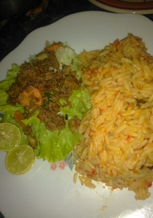 A picture of Jallof rice with salad.