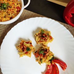 A picture of Tomato Rice with Masala Peanuts.