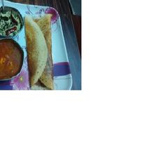 A picture of Dosa with Sambar.