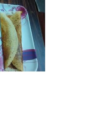 A picture of Dosa with Sambar.