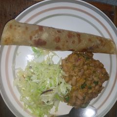 A picture of Chapati served with yellow beans and steamed cabbages.