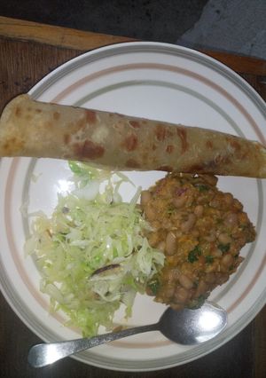 A picture of Chapati served with yellow beans and steamed cabbages.