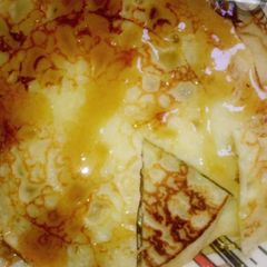 A picture of Pancake wit dazzling honey.