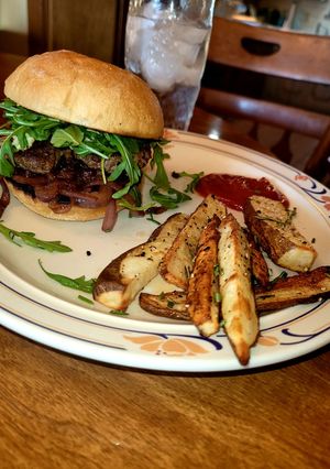 A picture of Carmalized Onion & Bleu Cheese Burger and Garlic Rosemary Fries.