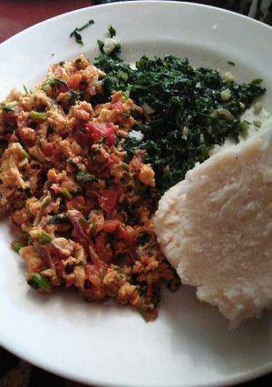 A picture of Kales/fried eggs and ugali.