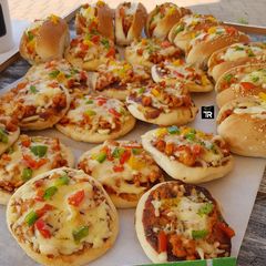 A picture of Mini chicken pizzas & Subs.