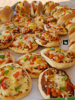 A picture of Mini chicken pizzas & Subs.
