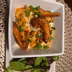 A picture of Crawfish/ smoked Gouda grits with crispy shrimp.