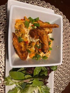 A picture of Crawfish/ smoked Gouda grits with crispy shrimp.