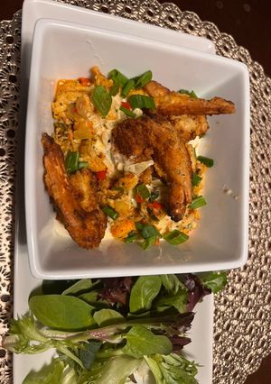 A picture of Crawfish/ smoked Gouda grits with crispy shrimp.