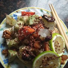 A picture of Tangy honey lemon fruit delight with roasted nuts and flax seeds.