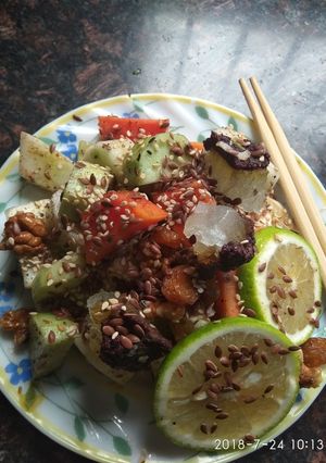 A picture of Tangy honey lemon fruit delight with roasted nuts and flax seeds.