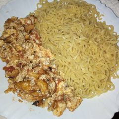 A picture of Boiled Indomie with fried eggs.