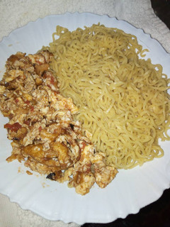 A picture of Boiled Indomie with fried eggs.