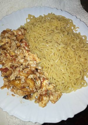 A picture of Boiled Indomie with fried eggs.