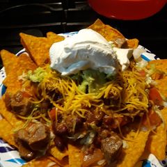 A picture of Nachos with leftover eye of round chili.