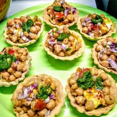 A picture of Baked mathri tarts with dahi bhale chole stuffing.