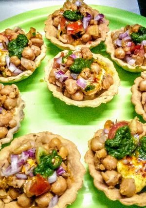 A picture of Baked mathri tarts with dahi bhale chole stuffing.