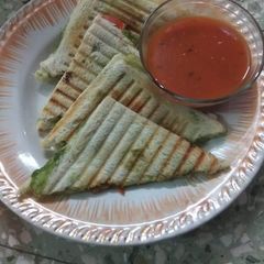 A picture of Vegetable sandwich with tomato soup.